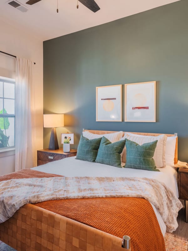 Model bedroom with lots of natural light and a ceiling fan at District Flats in Charlotte, North Carolina