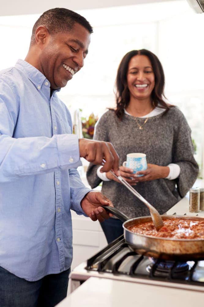 Couple cooking in their kitchen at Coeur D'Alene Plaza in Spokane, Washington