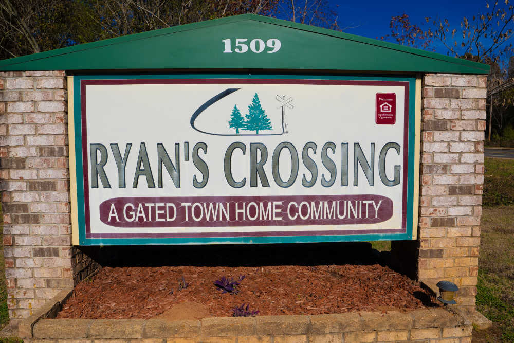 A monument sign of the apartment homes at Ryan's Crossing in Marshall, Texas