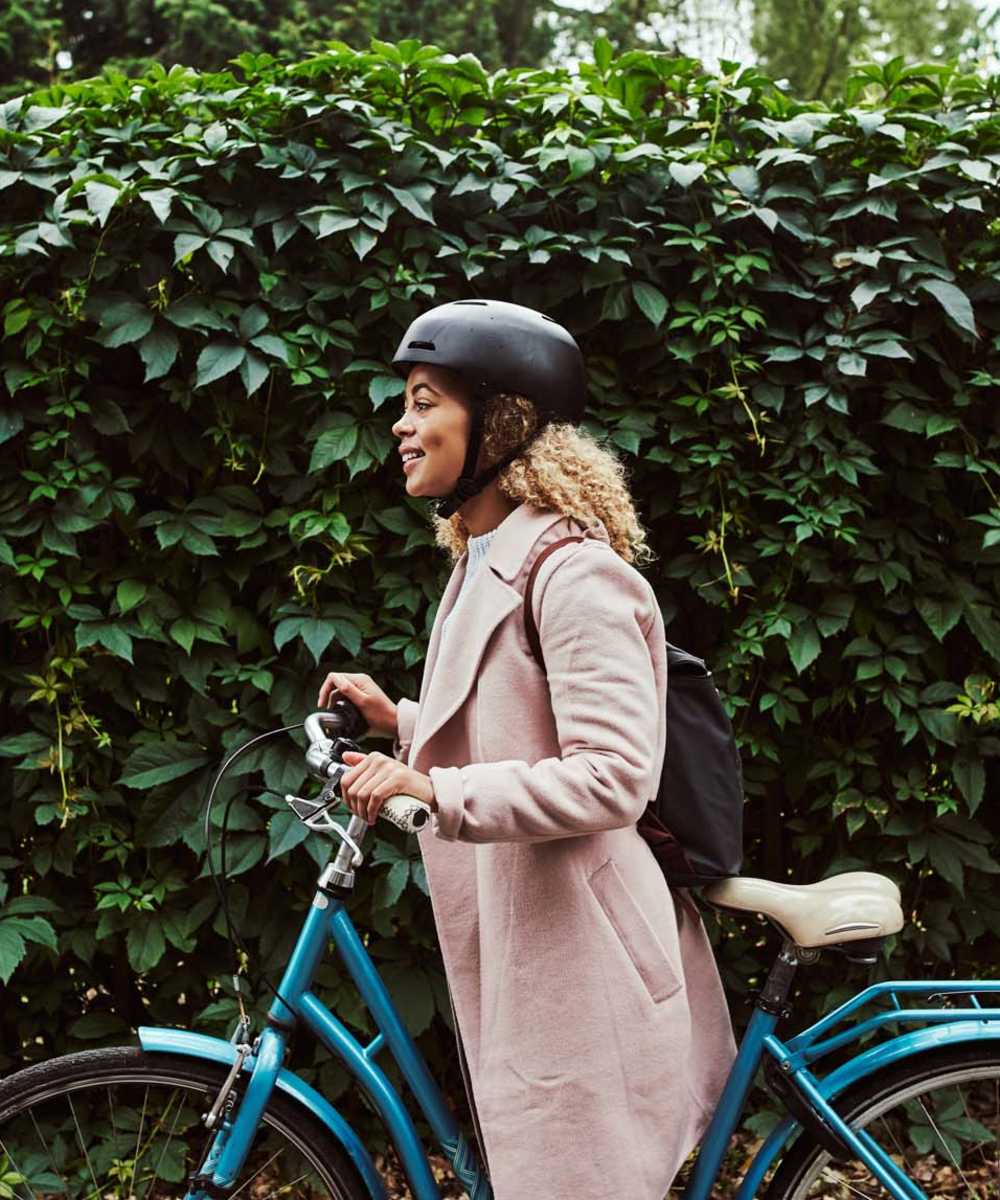 Resident riding bike near Strata Apartments in Denver, Colorado     