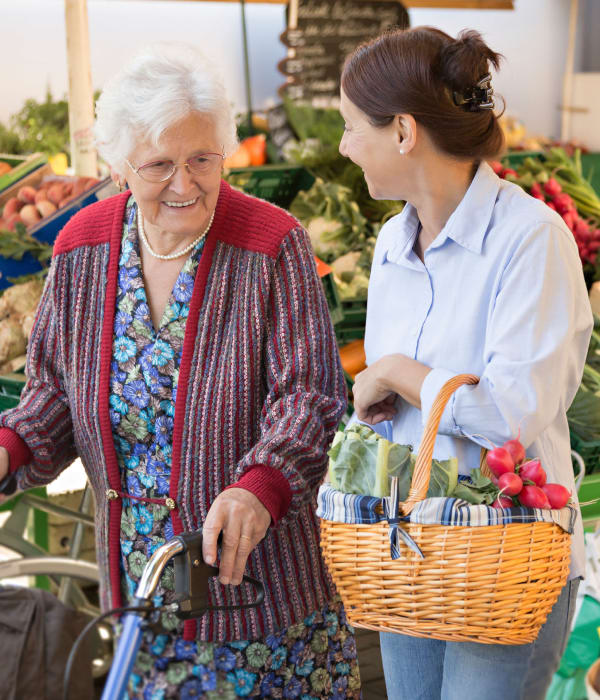 Resident and caretaker shopping at the grocery store near The Colonial at Historic Camden in Camden, South Carolina