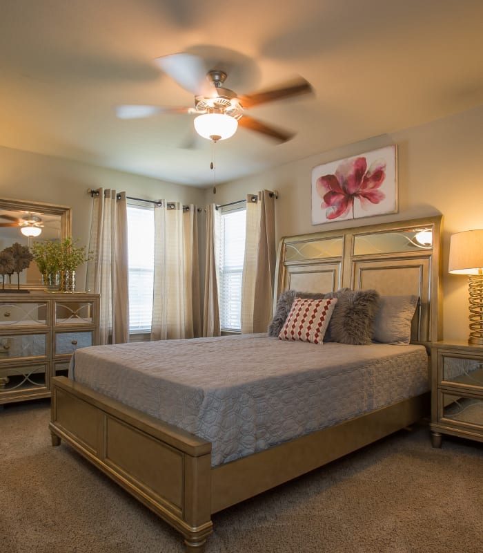 Chic bedroom with ceiling fan at Tuscany Ranch in Waco, Texas