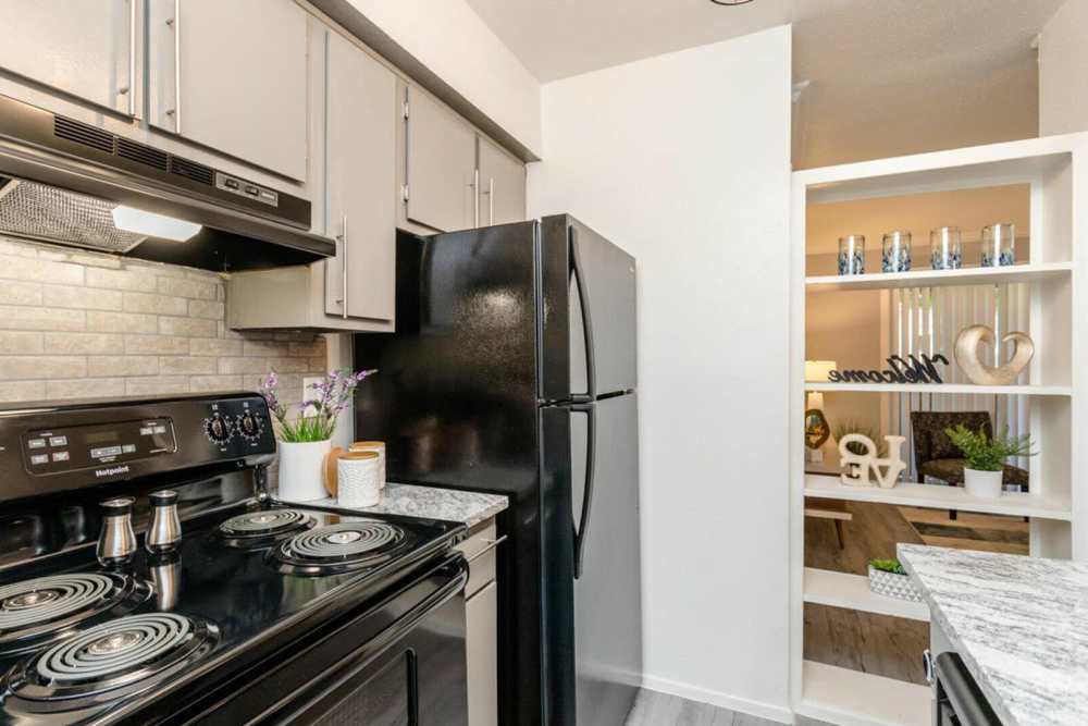 Kitchen with a range and refrigerator at Ridge Point in Houston, Texas