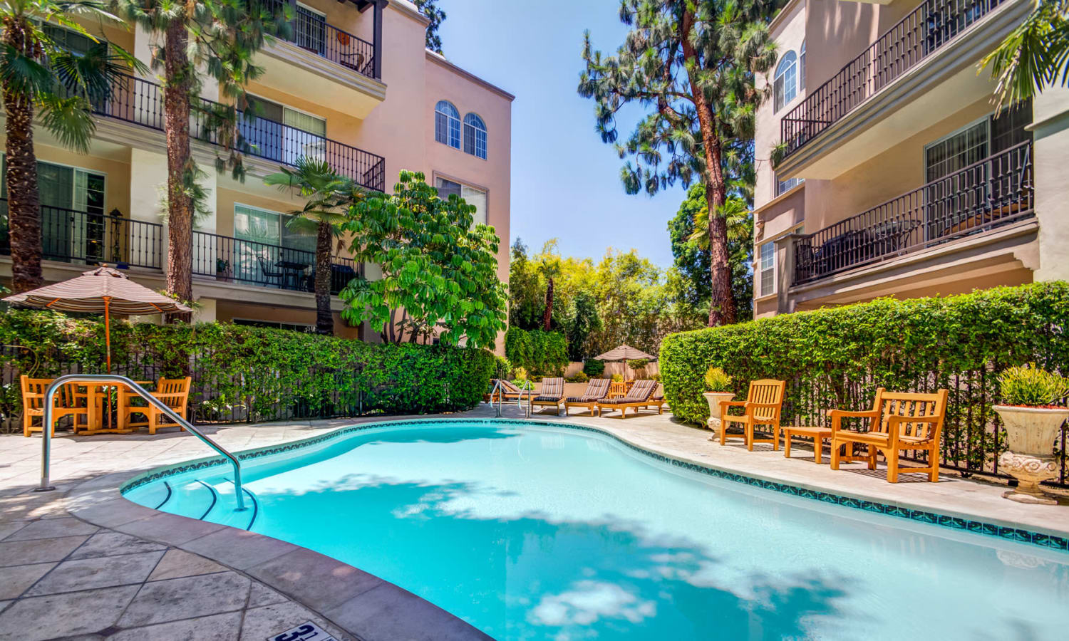 Resort-style swimming pool on a beautiful day at L'Estancia in Studio City, California