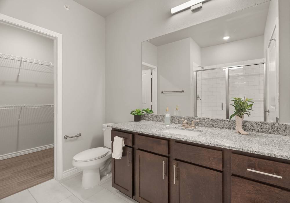 Bright bathroom with glass sliding doors at Walnut Springs in Seguin, Texas