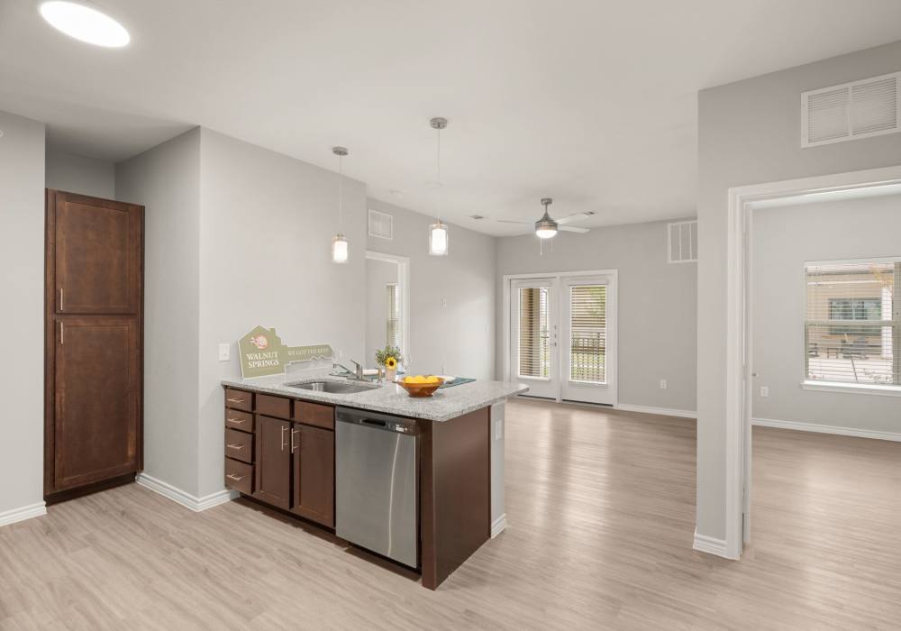 Open living area with kitchen at Walnut Springs in Seguin, Texas