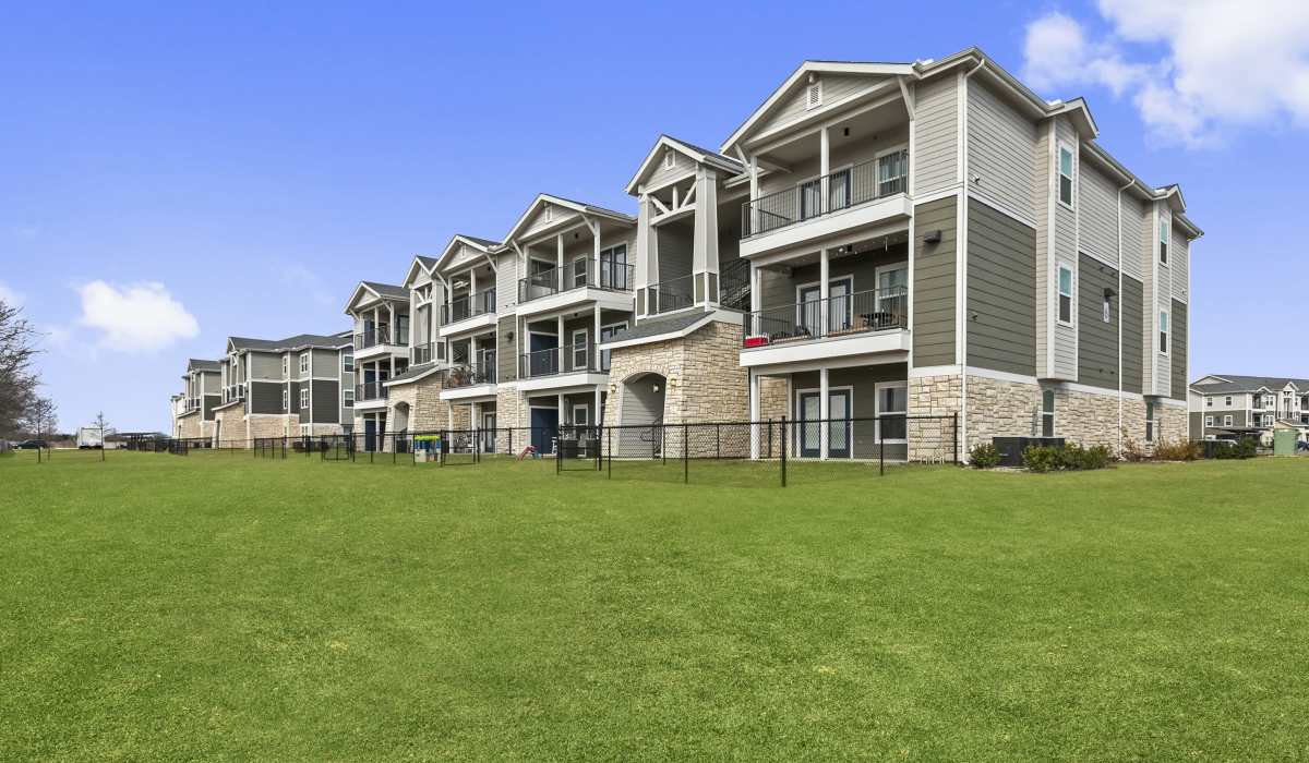 Exterior view of the community with greenery at Canyon House in New Braunfels, Texas