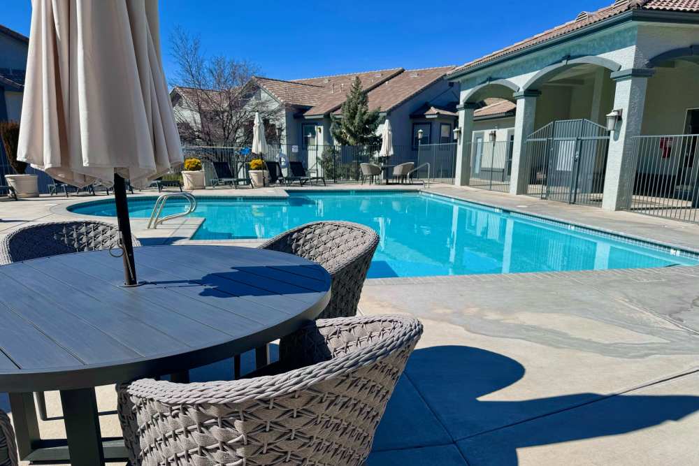 Outdoor pool with patio seating at Canyon Vista in Sparks, Nevada