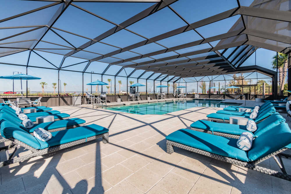 Indoor luxury pool with plenty of lounge chairs at Vue on Lake Monroe in Sanford, Florida