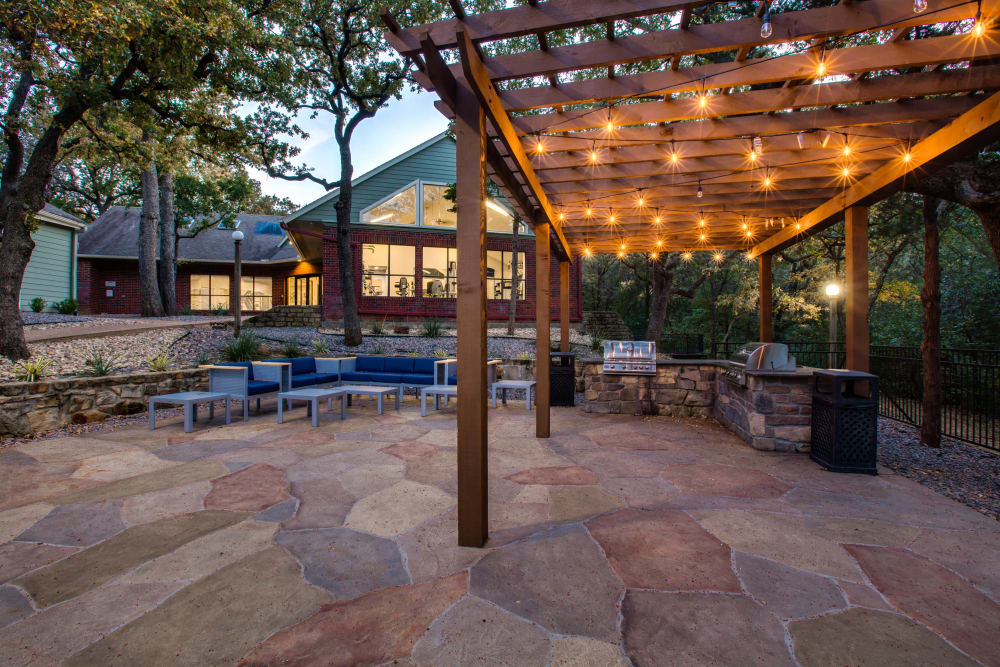 Twinkle lights hung near outdoor seating at Verandahs at Cliffside Apartments in Arlington, Texas