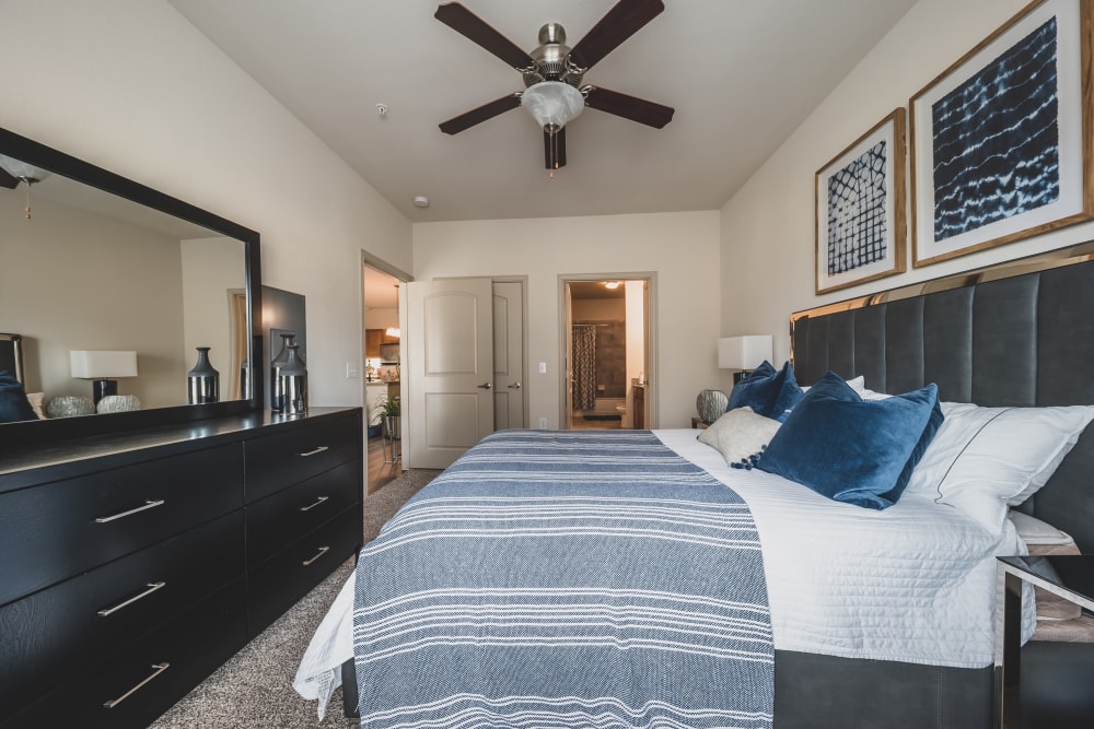 Bedroom with vanity mirror at Evolv in Mansfield, Texas