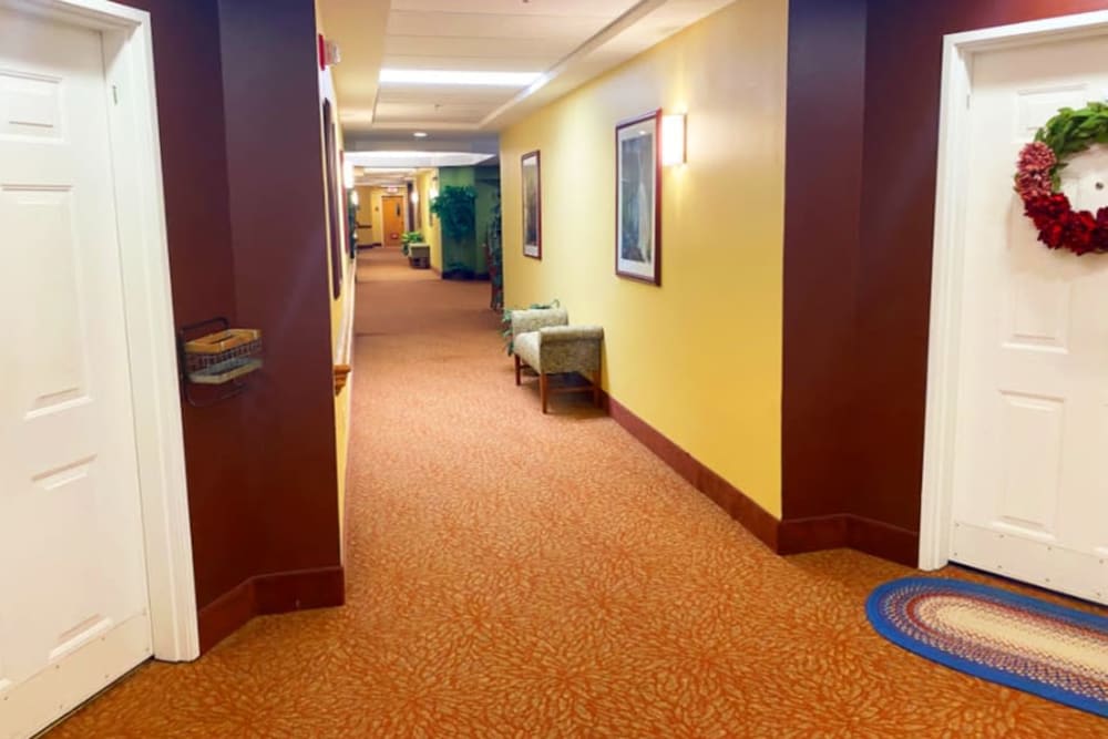 Wide and well lit hallway at The Iris Senior Living in Great Falls, Montana. 