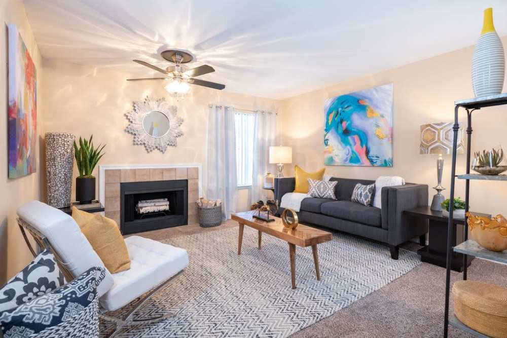 Living room with large couch, chair and fireplace at The Pines of Palos Verdes in Mesquite, Texas