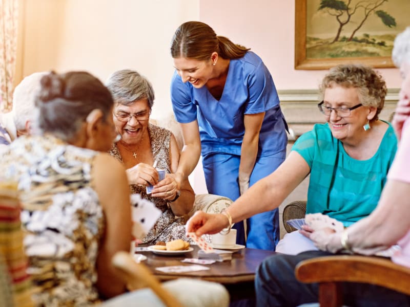 Residents having fun spending time with their caretaker at East Troy Manor in East Troy, Wisconsin