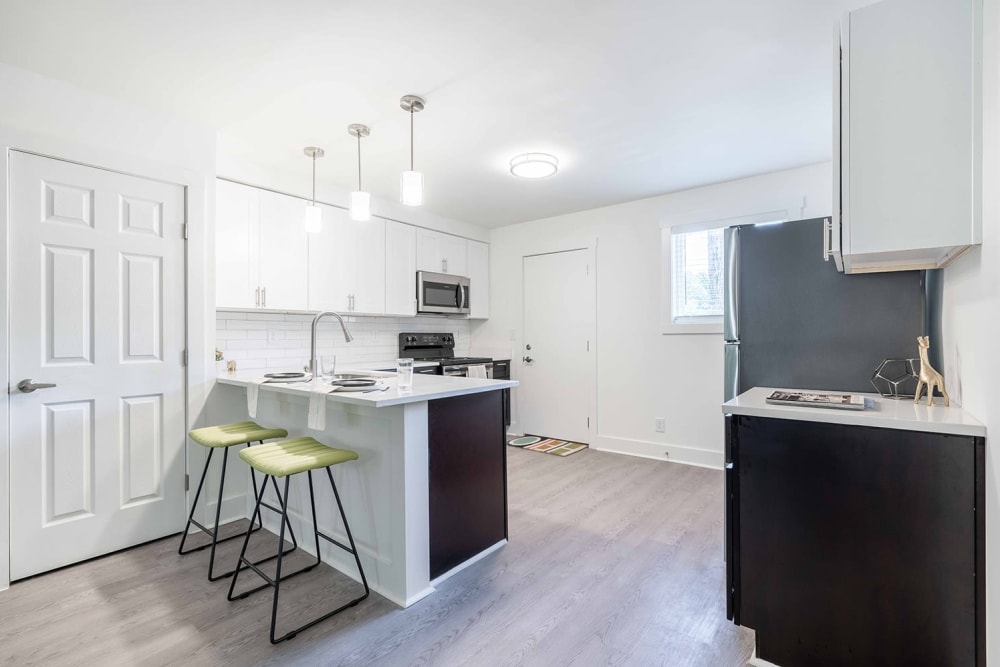 Ample natural light and quartz countertops in a model apartment's kitchen at The Motif by Morningside in Atlanta, Georgia