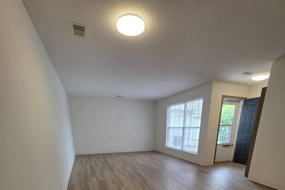 Spacious living room with wood-style flooring at Cottages of Shippensburg in Shippensburg, Pennsylvania