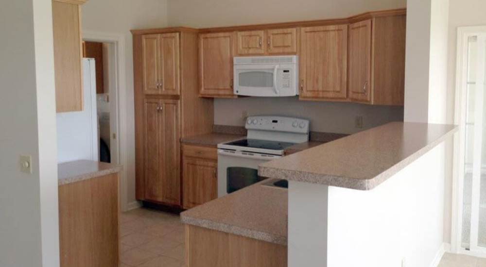 Kitchen with wooden cabinets at Villas of Brighton in Rochester, New York