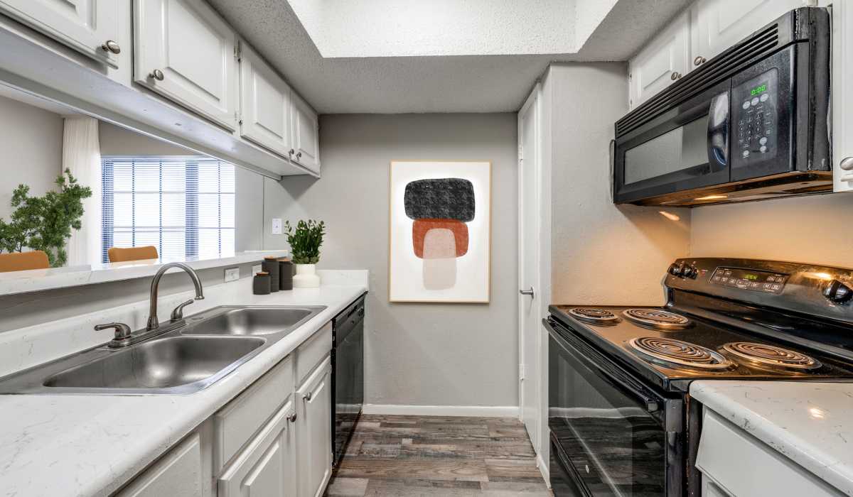 Kitchen with wooden cabinets at Icon Apartments in San Antonio, Texas