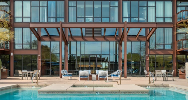 Resident enjoying a drink poolside at Domus in Phoenix, Arizona