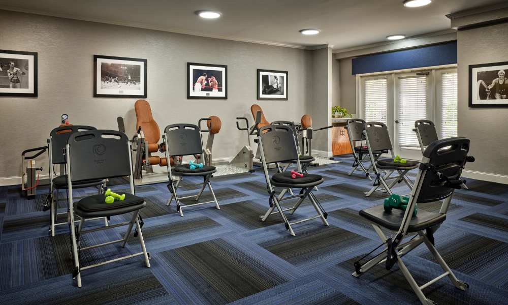 Activity room with seating and fitness equipment at Waltonwood Cotswold in Charlotte, North Carolina  