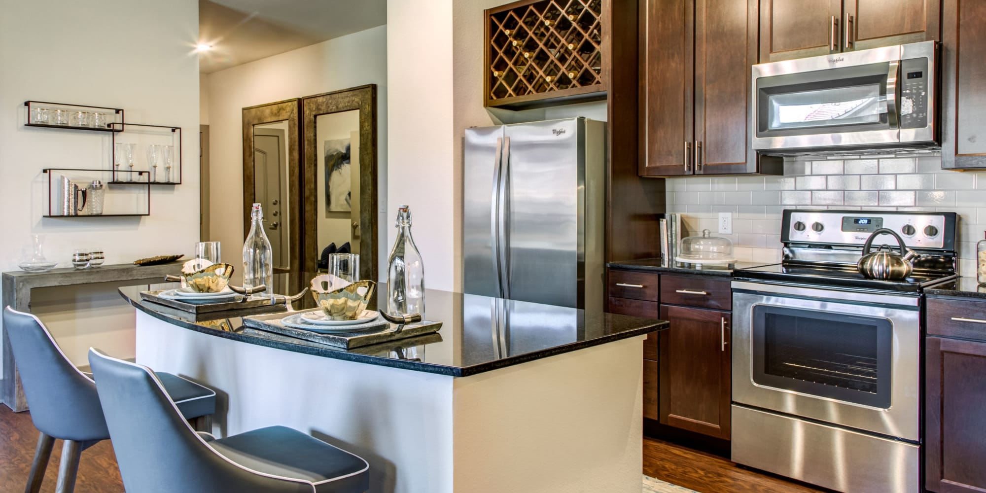 Well-furnished kitchen area with hardwood floors in a model home at Waterford Trails in Spring, Texas