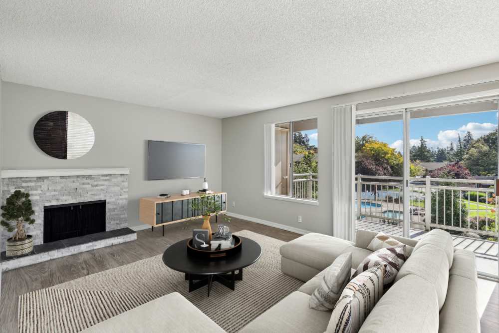 Living room with television, recliners and a fireplace at Cascade Park Apartment Homes in Vancouver, Washington