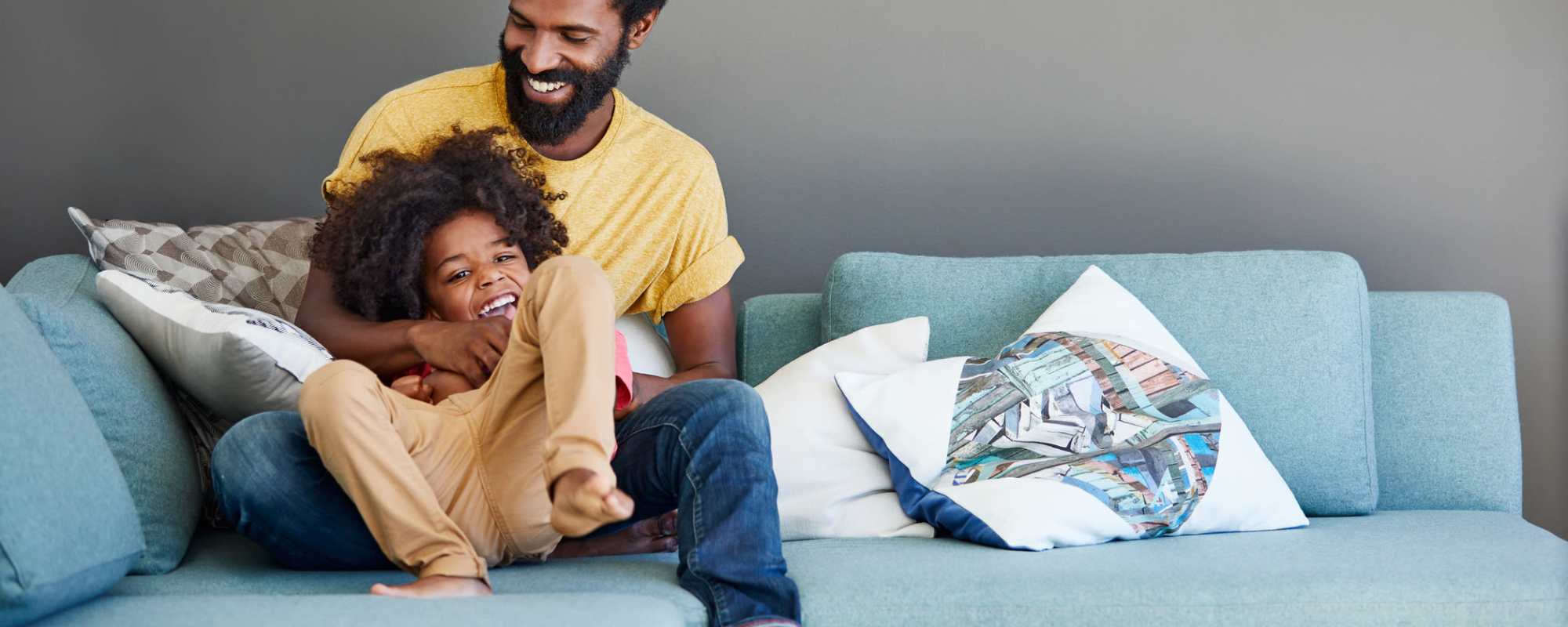 Father playing with his kid in thier new home at ARTISAN Management Group in Des Moines, 