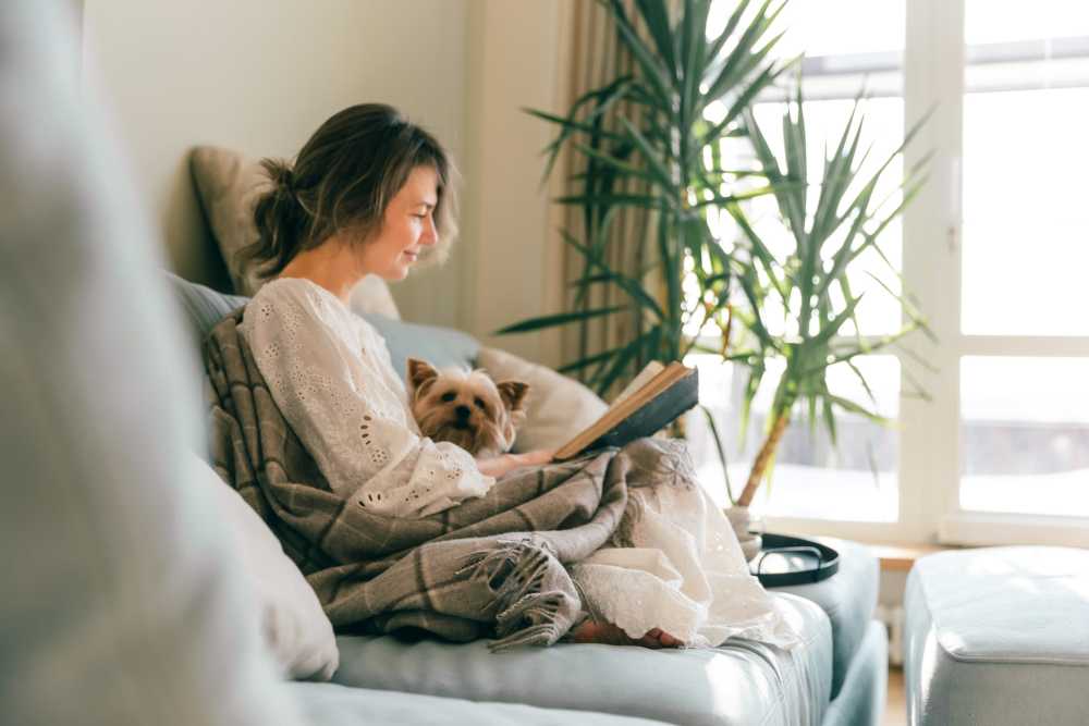 Women on couch with her dog at Stonehurst Manor and Harrison Court in Upper Darby Township, Pennsylvania