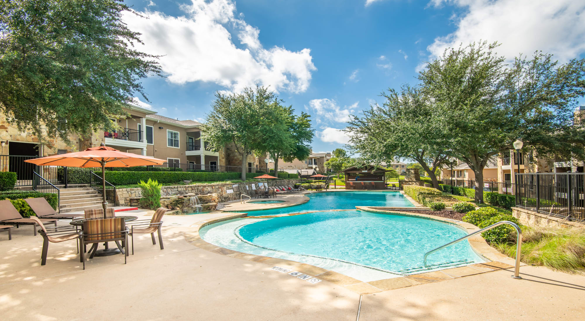 Outdoor pool area at El Lago Apartments in McKinney, Texas