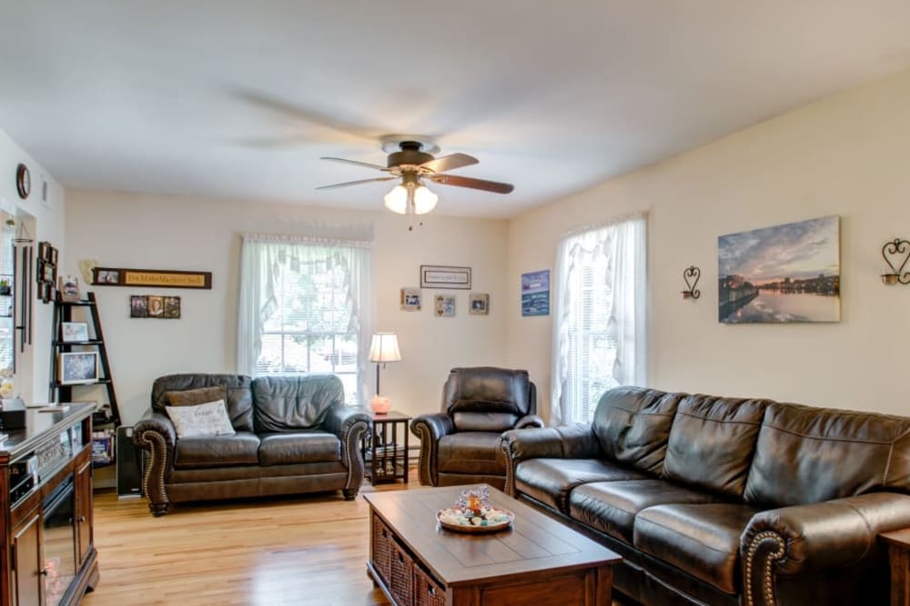 Living room with leather couches at Brandywyne East II in Brielle, New Jersey