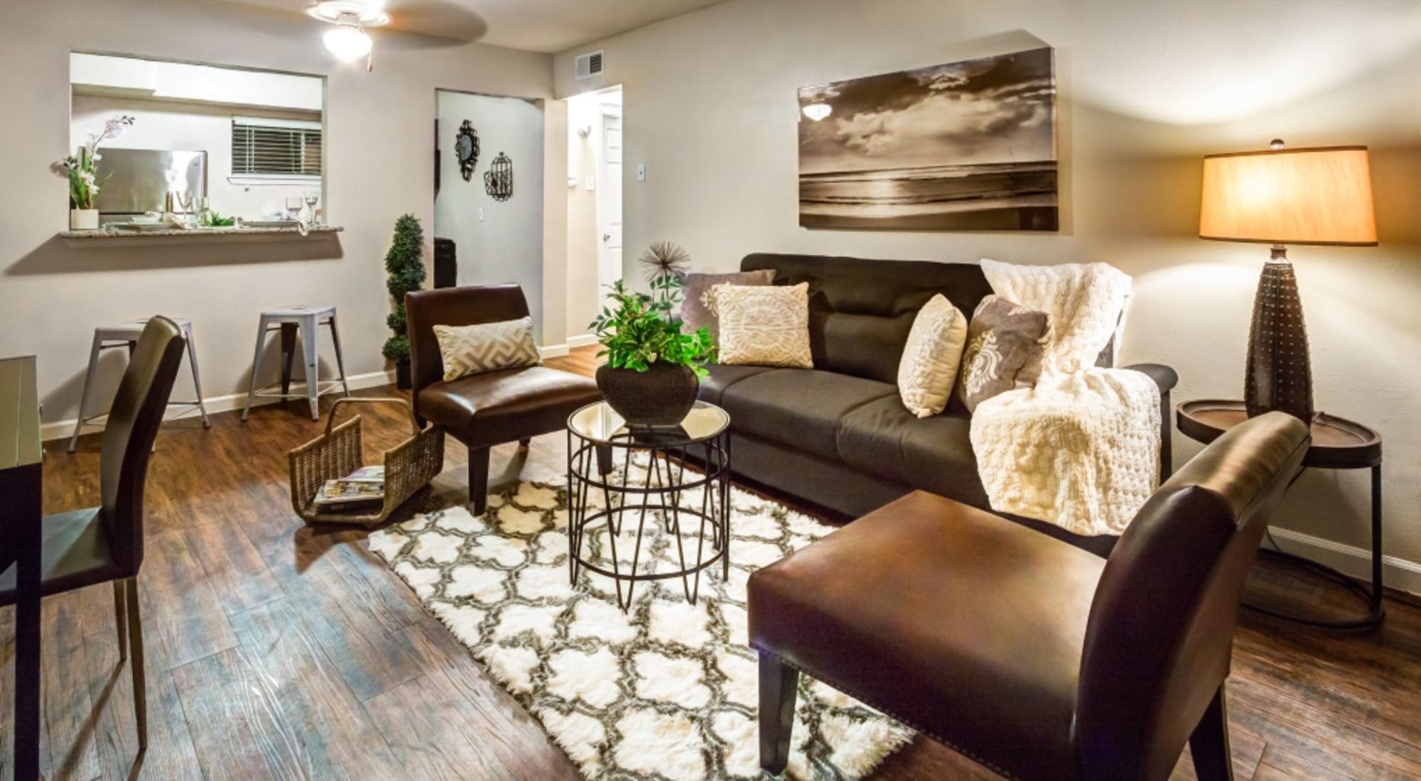 Livingroom with brown chairs and sofa at The Shavelson in Houston, Texas