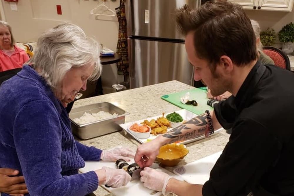 Resident in a cooking class at Inspired Living Lewisville in Lewisville, Texas