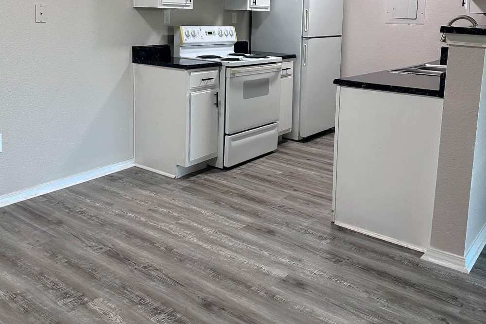 Dining area with view to kitchen at The Gardens At Pryor Creek in Pryor, Oklahoma
