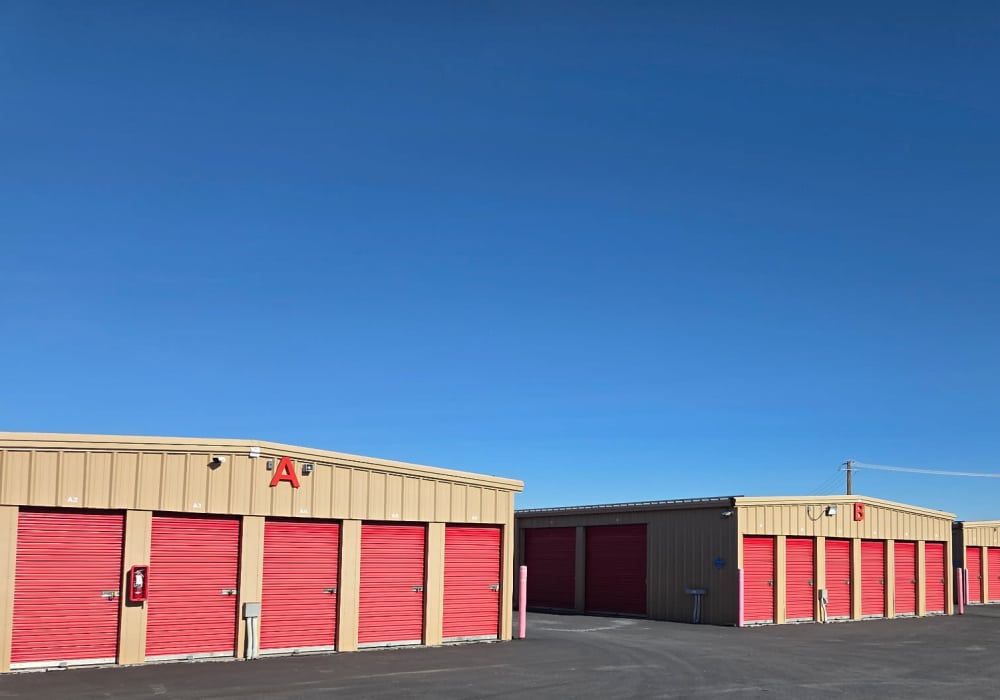 A row of red self storage unit doors for rent at BuxBear Storage Idaho Falls in Idaho Falls, Idaho
