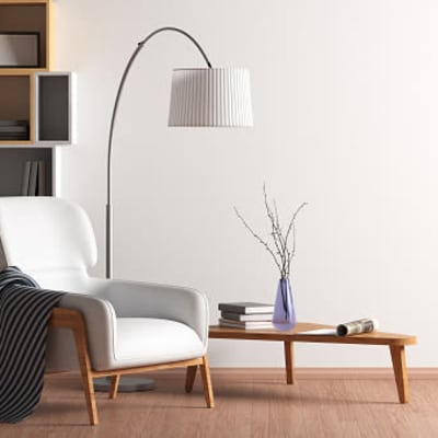 Modern upholstered chair and lamp next to wooden coffee table at The Collection Townhomes in Dallas, Texas