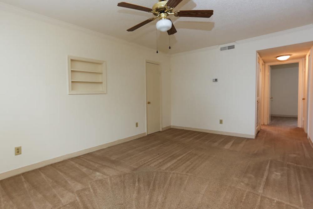 Well-lit apartment living area with ceiling fan at Landmark Apartments in Chesapeake, Virginia