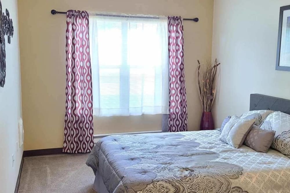 Serene bedroom in apartment at Lakeland Senior Living in Eagle Point, Oregon. 