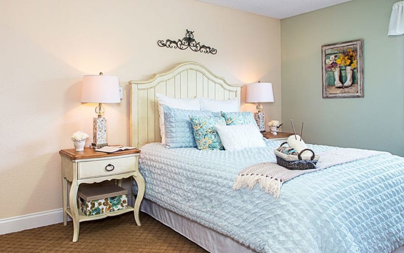 Cozy bedroom with nightstand at Grand Villa of Lakeland in Lakeland, Florida