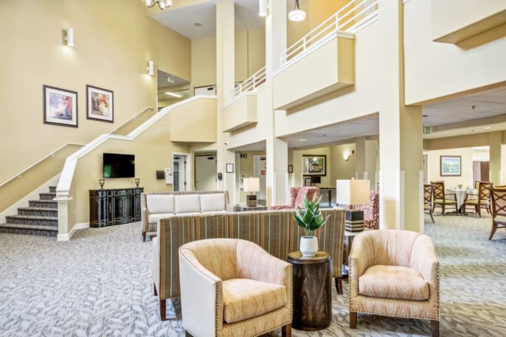 Elegant lobby with staircase at Woodside Senior Living in Springfield, Oregon