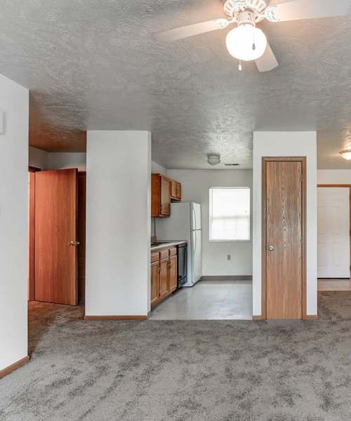 Living room with ceiling fan at Oakmont Greene I in Mount Hope, West Virginia