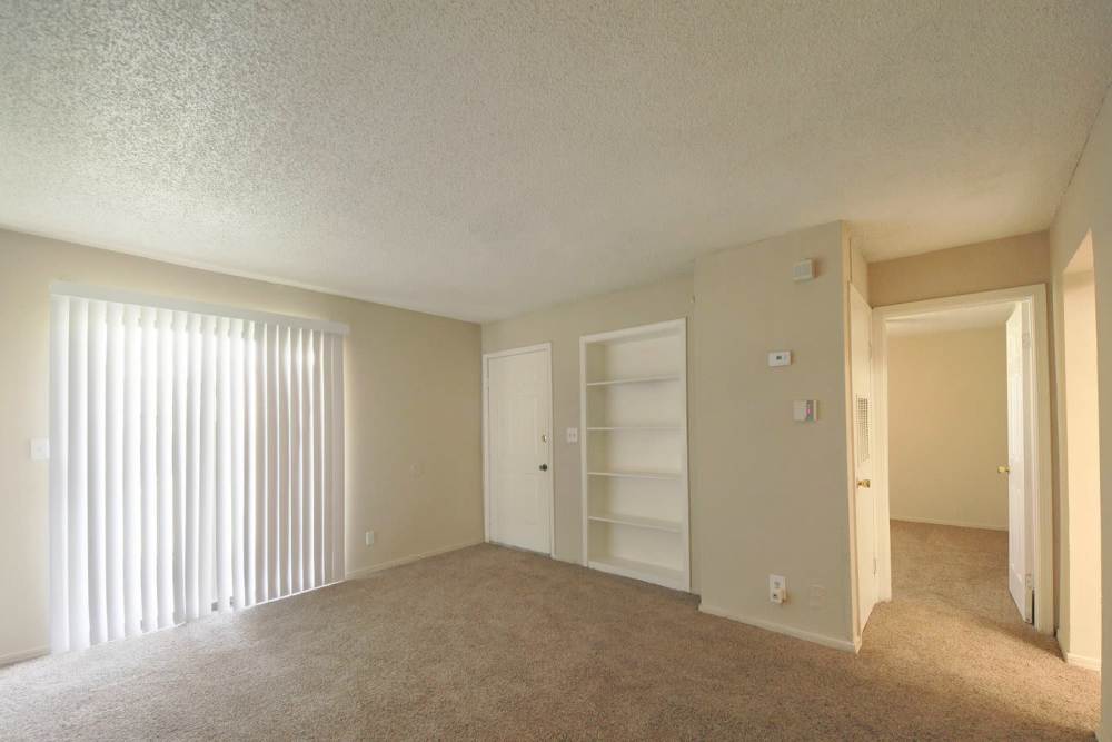 Unfurnished living room with access to balcony at Stonebrook in Oklahoma City, Oklahoma
