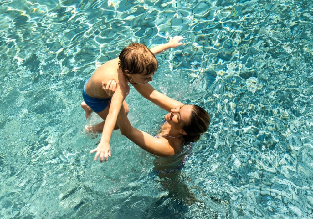 Residents swimming at  Mercado Apartments in Perris, California