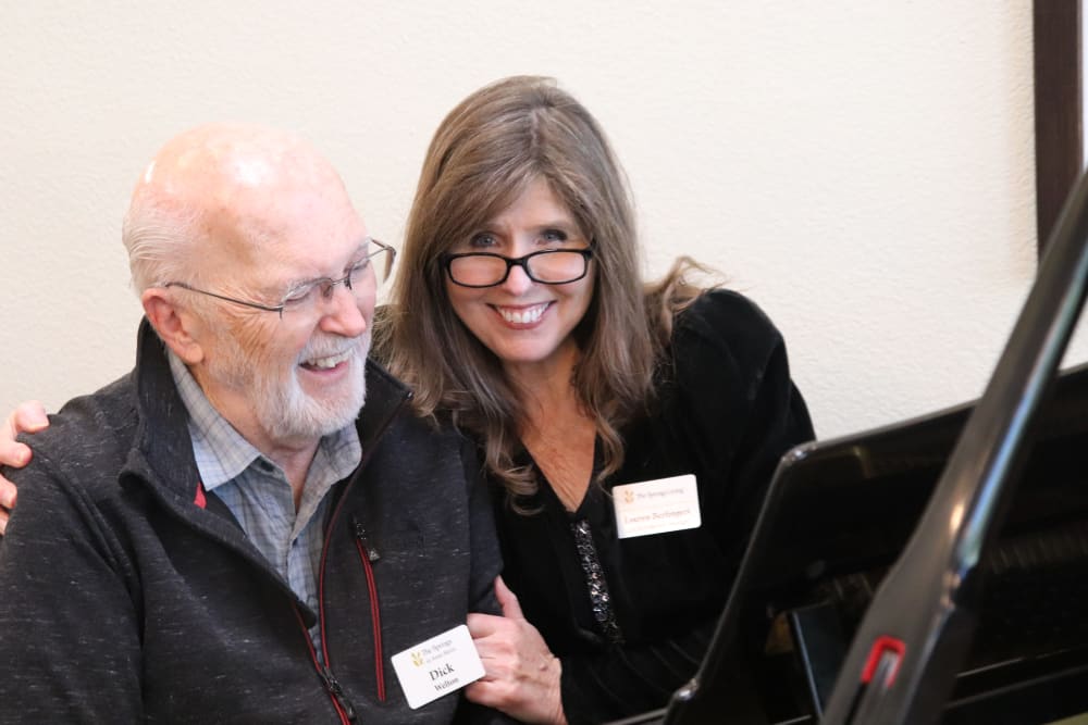 Resident and staff member playing the piano at The Springs at Anna Maria in Medford, Oregon