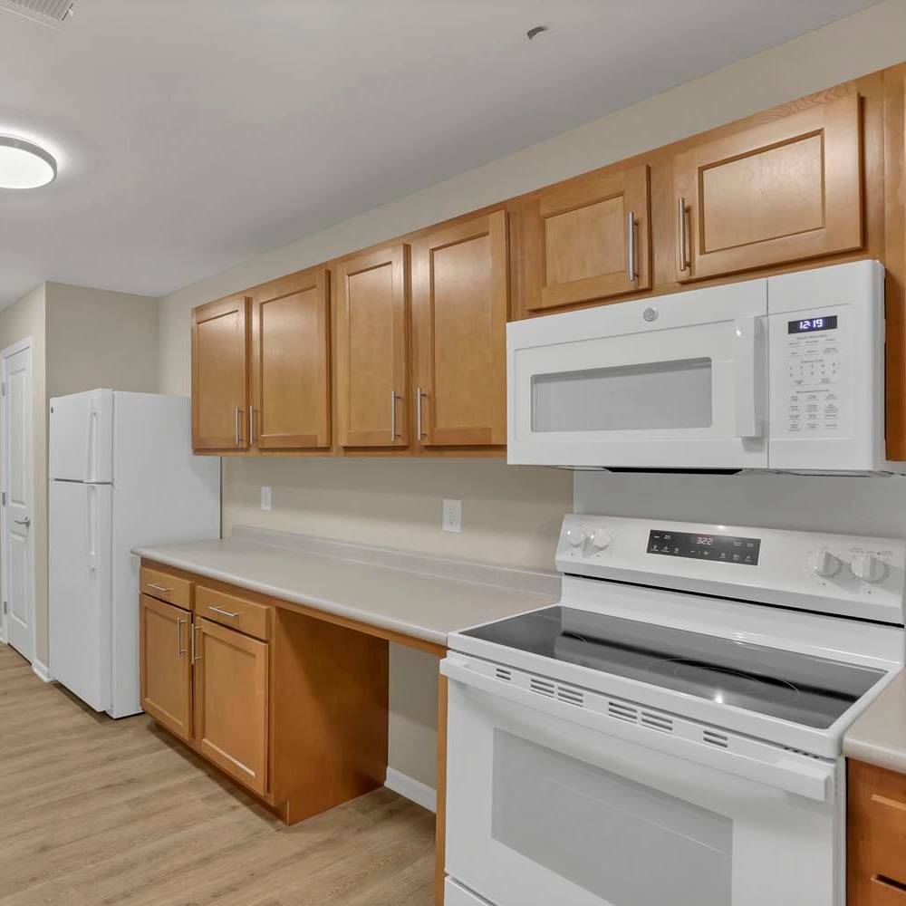 White stove with oven and microwave above at The Lofts On First in The Plains, Ohio