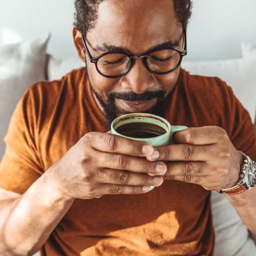 A resident enjoying his morning coffee at Park Hacienda Apartments in Pleasanton,California