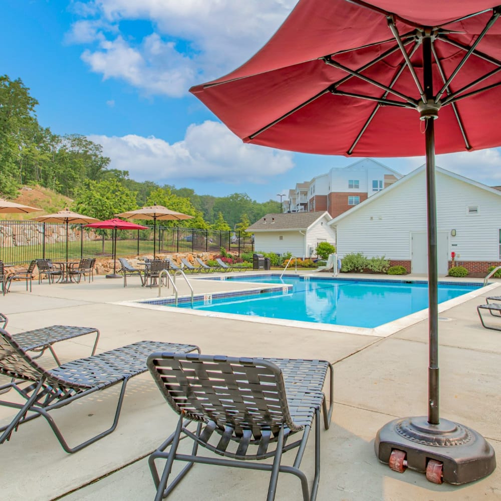 Pool with lounge chairs and umbrellas at Highland Hills, Cumberland, Rhode Island