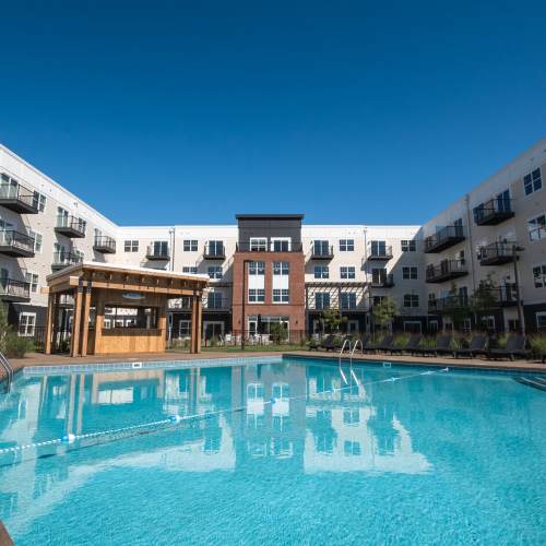 Swimming pool with sun deck at Mirada Apartments in Lewis Center, Ohio