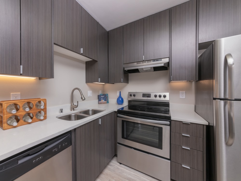 Model studio apartment home's well-decorated kitchen area with stainless steel appliances at Mia in Palo Alto, California