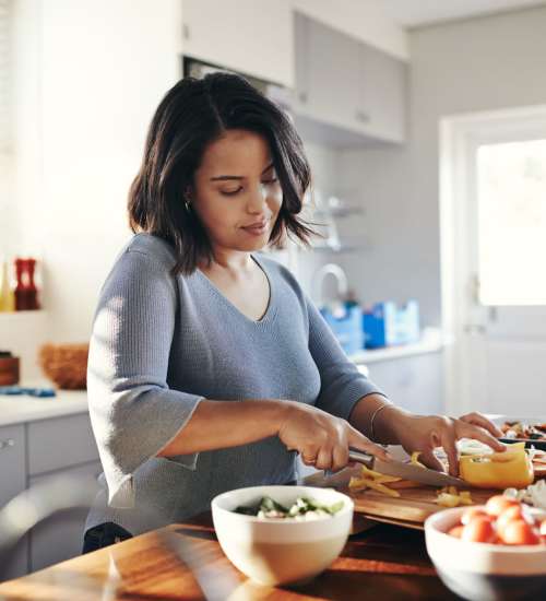 Resident cooking at Greer Mill Residences in Greer, South Carolina