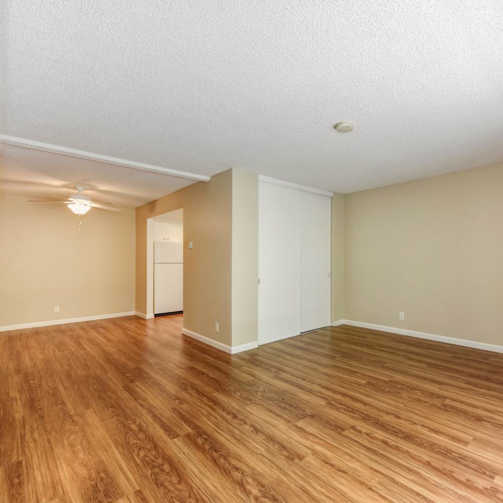 Spacious living room with wood-style flooring at Fayette Arms Apartments in Mountain View, California,